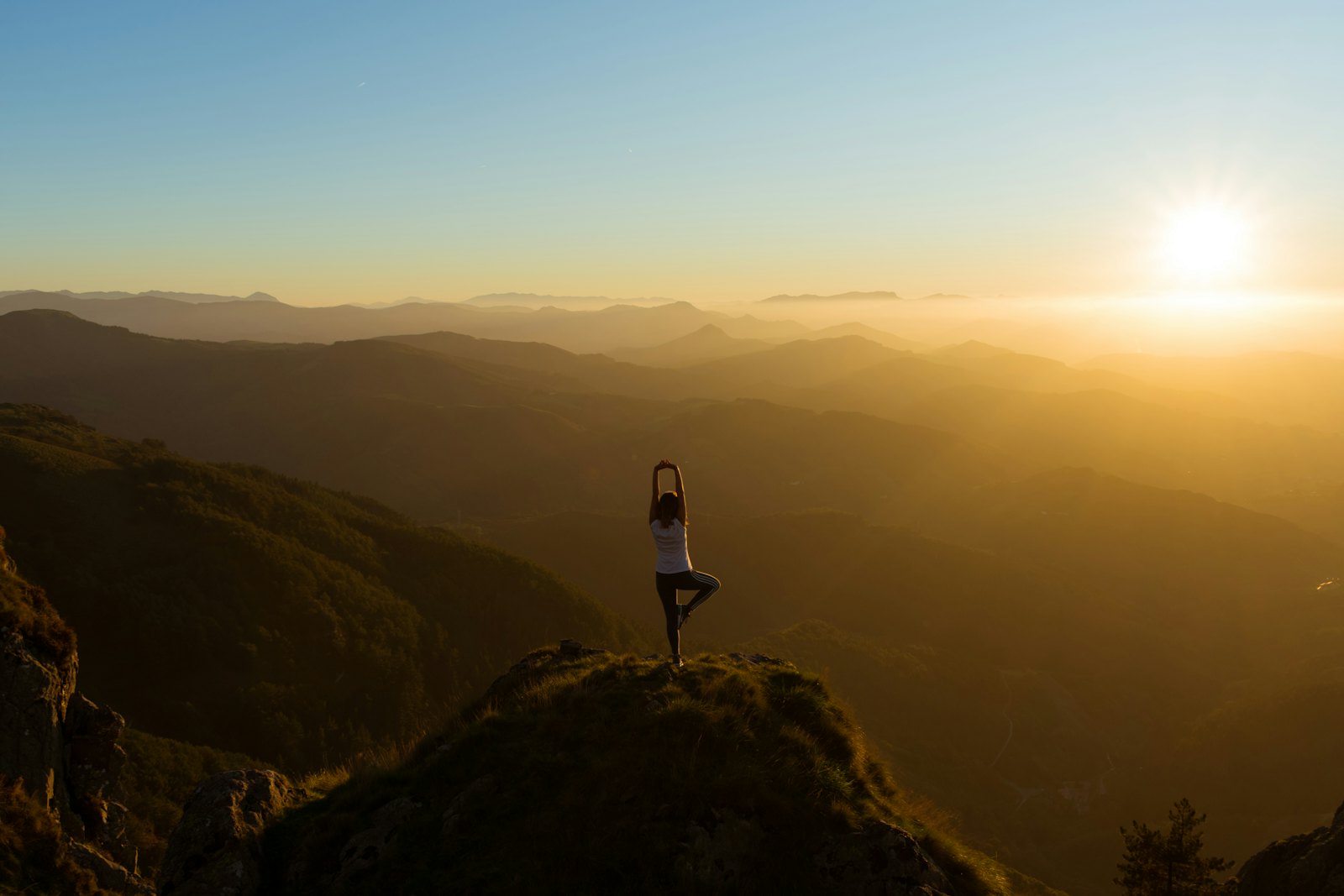 Person practicing mindful yoga outdoors, demonstrating the integration of body and mind awareness in mindfulness therapy